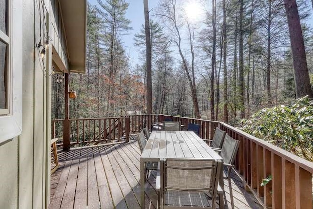 wooden terrace featuring outdoor dining area