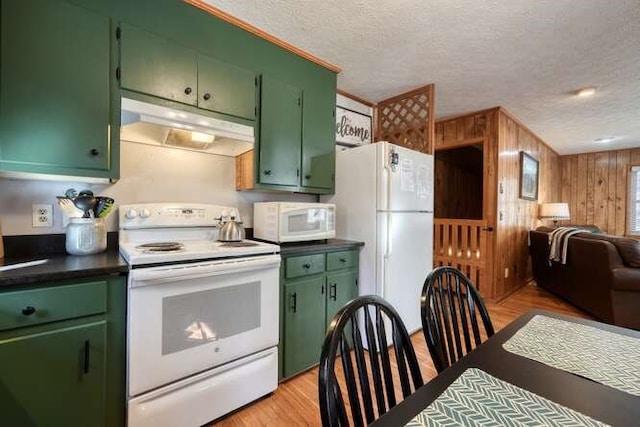 kitchen featuring white appliances, open floor plan, under cabinet range hood, and green cabinetry