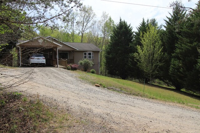 140 Hannel Dr, Murphy, NC 28906 - ranch-style house with dirt driveway, a front lawn, and a carport