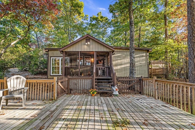 wooden deck featuring a sunroom