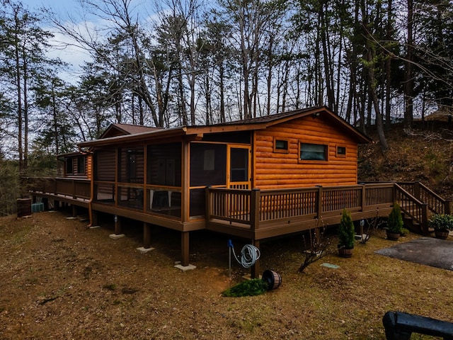 back of property featuring a deck and log veneer siding