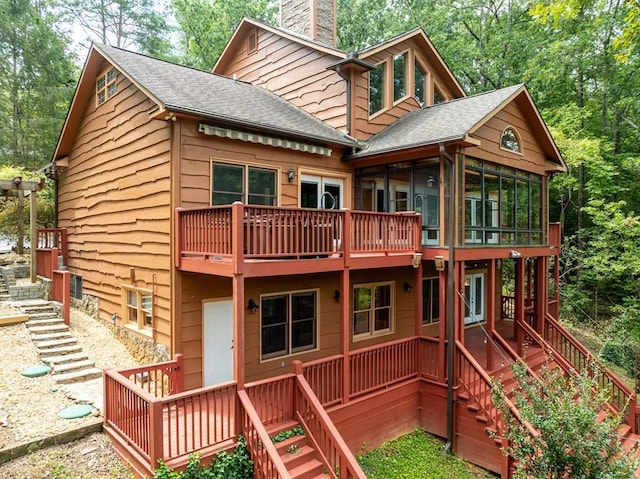 exterior space featuring a sunroom and a deck