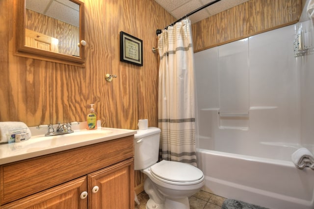 full bathroom featuring toilet, tile patterned floors, shower / bath combo, vanity, and wood walls