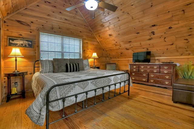 bedroom with lofted ceiling, wood walls, wood finished floors, wood ceiling, and a ceiling fan