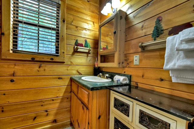 bathroom featuring wooden walls and vanity
