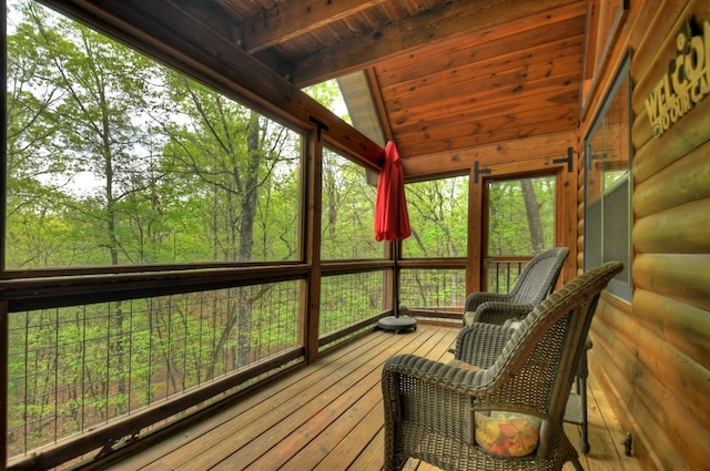 sunroom / solarium featuring vaulted ceiling