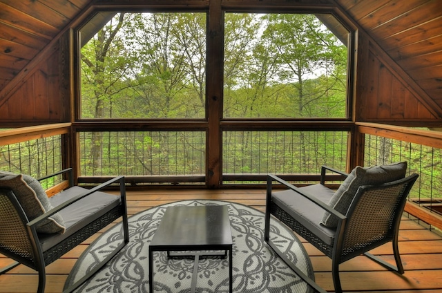 sunroom / solarium featuring lofted ceiling