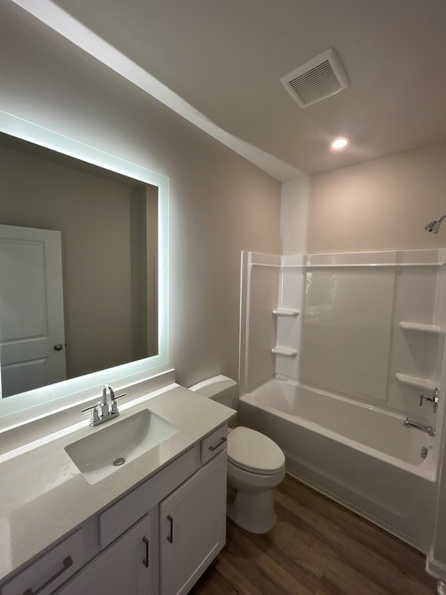 full bathroom with vanity,  shower combination, toilet, and wood-type flooring