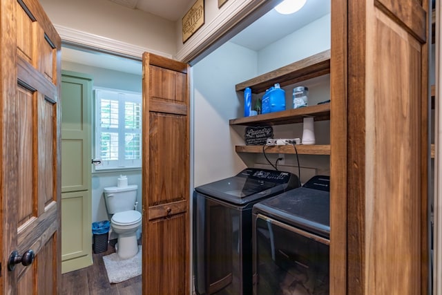 clothes washing area with laundry area, dark wood finished floors, and washing machine and clothes dryer