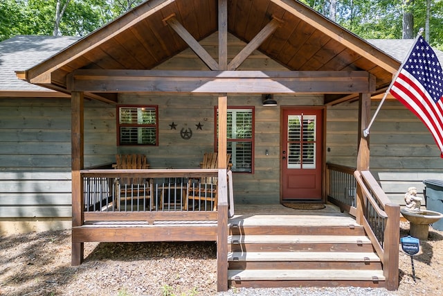 property entrance with a shingled roof