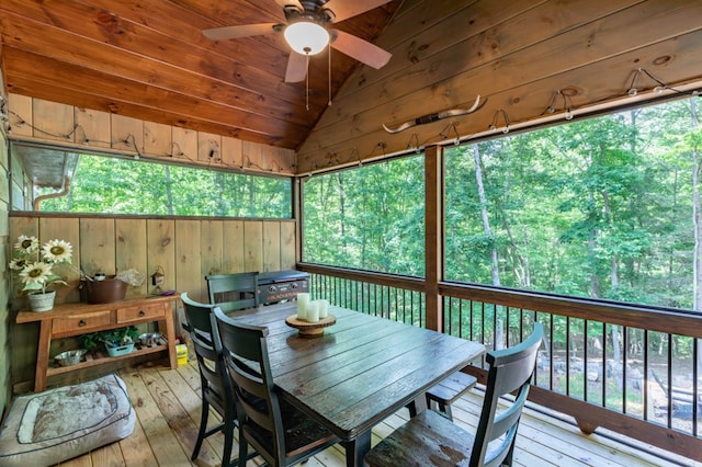 sunroom with a ceiling fan, wooden ceiling, and vaulted ceiling