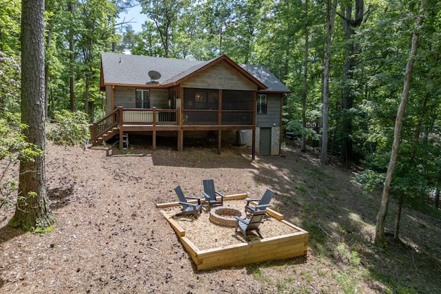 back of house with a deck, stairway, a sunroom, and a fire pit