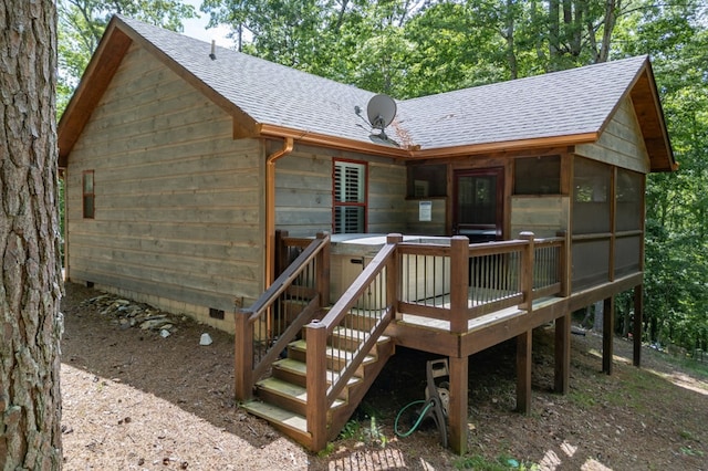 rear view of property with a deck, roof with shingles, crawl space, and a sunroom