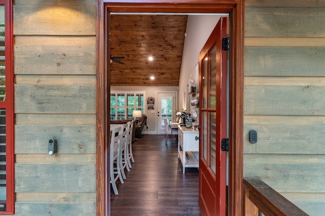 hallway featuring dark wood finished floors and baseboards