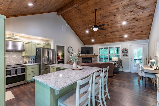 kitchen featuring green cabinets, wall chimney exhaust hood, appliances with stainless steel finishes, and dark wood finished floors