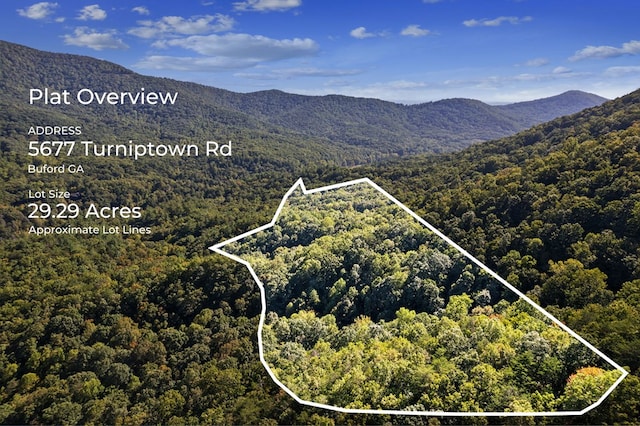 birds eye view of property with a mountain view