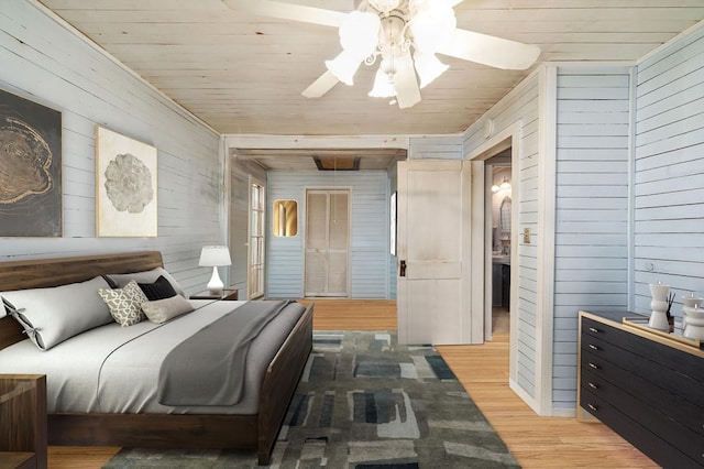 bedroom featuring hardwood / wood-style floors, ceiling fan, wooden walls, and wood ceiling