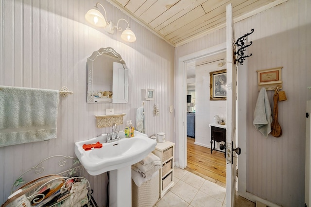 bathroom with tile patterned flooring, wood walls, and wood ceiling