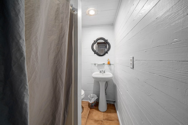 bathroom with tile patterned flooring and toilet