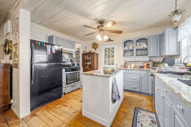 kitchen featuring stainless steel appliances, gray cabinetry, light hardwood / wood-style flooring, and light stone counters