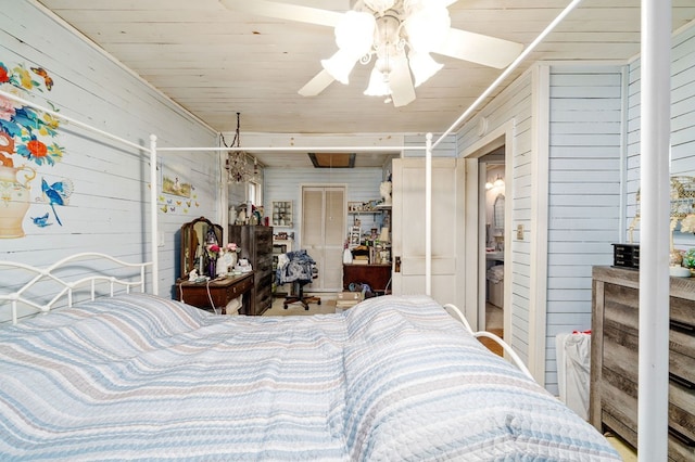 bedroom featuring wood walls and ceiling fan