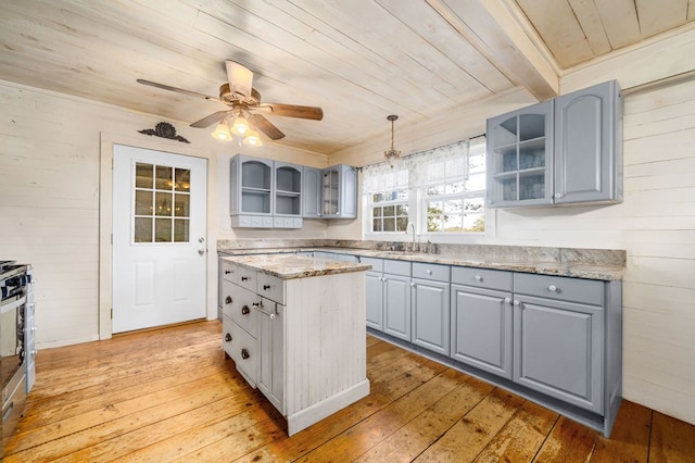 kitchen with gray cabinets, decorative light fixtures, wooden ceiling, and light hardwood / wood-style flooring