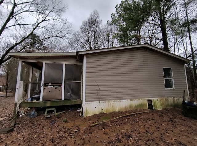 view of side of property featuring a sunroom