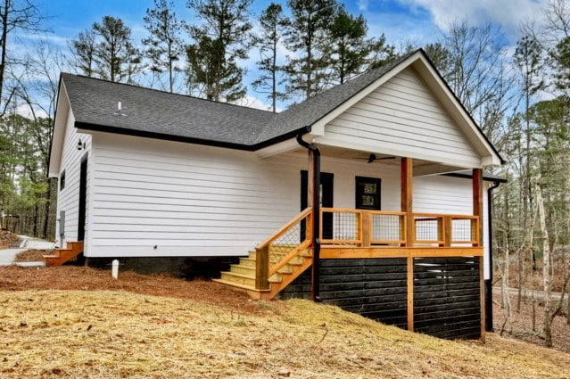 exterior space with ceiling fan, a porch, and a shingled roof