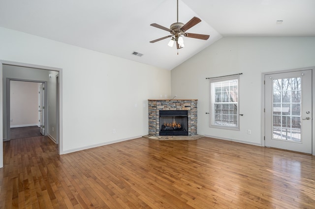 unfurnished living room featuring hardwood / wood-style floors, a fireplace, ceiling fan, and vaulted ceiling