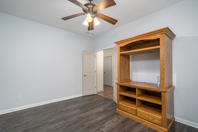 unfurnished bedroom featuring ceiling fan and dark hardwood / wood-style flooring