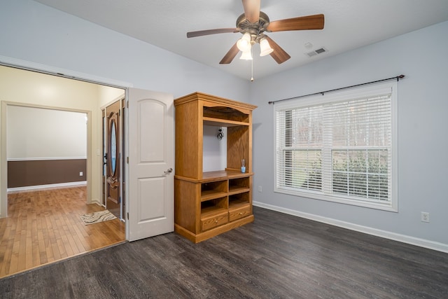 unfurnished bedroom featuring dark hardwood / wood-style floors and ceiling fan