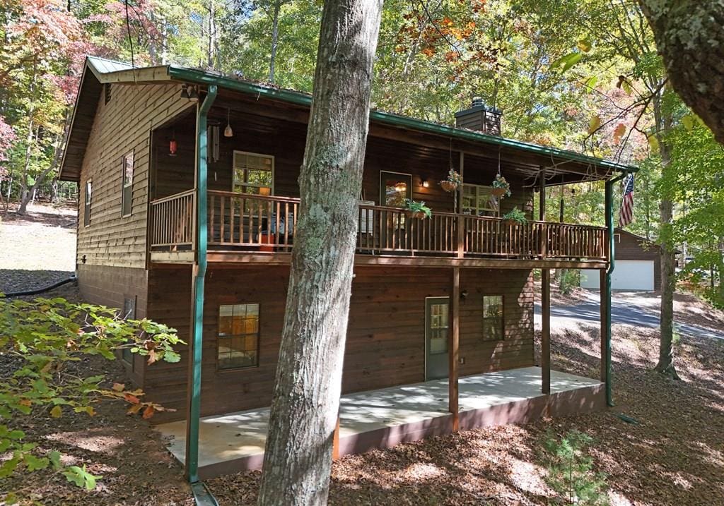 rear view of property with a wooden deck