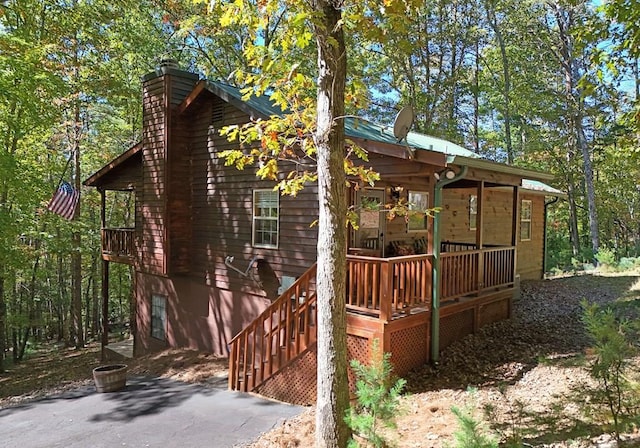 view of property exterior featuring a wooden deck