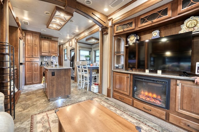 kitchen with sink and a center island with sink