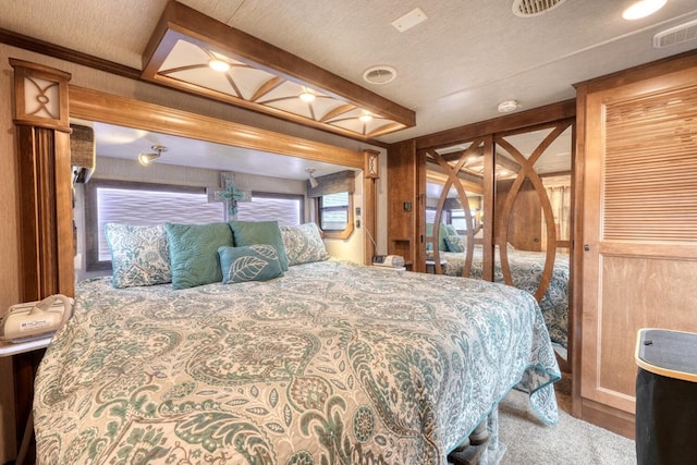 bedroom featuring beamed ceiling and access to exterior