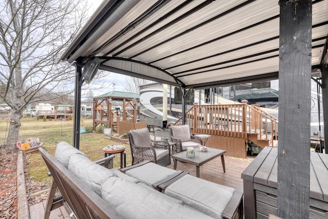 wooden deck featuring a gazebo and outdoor lounge area