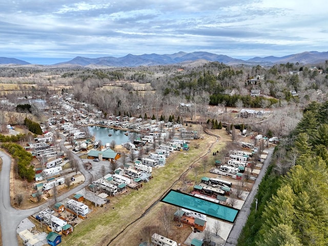 bird's eye view with a water and mountain view