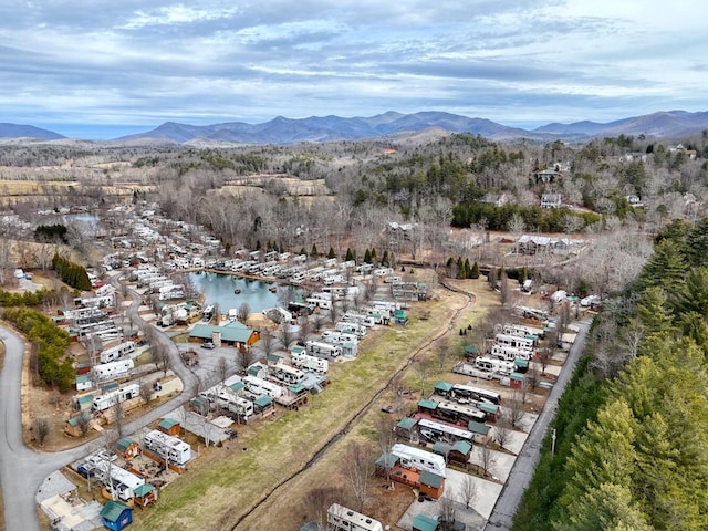 drone / aerial view featuring a water and mountain view