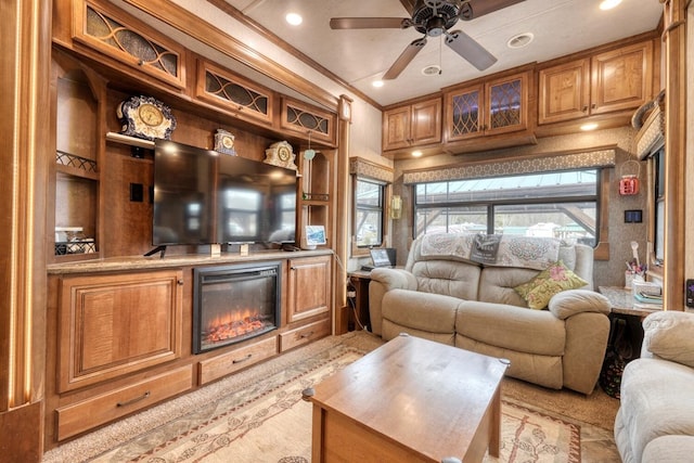 living room featuring crown molding and ceiling fan