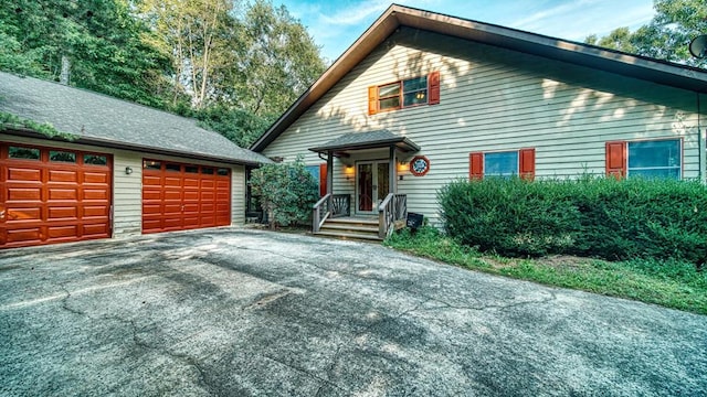 view of front of home with a garage and an outdoor structure