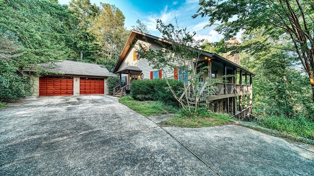 view of front of property with an outdoor structure and a detached garage