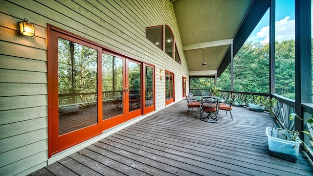 wooden terrace featuring outdoor dining space and french doors