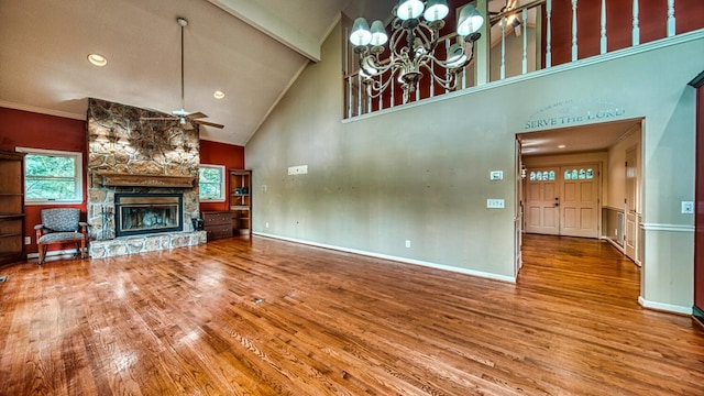 unfurnished living room featuring ceiling fan, a fireplace, wood finished floors, and baseboards