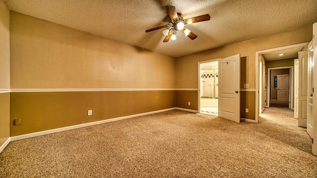 carpeted spare room with a ceiling fan, a textured ceiling, and baseboards