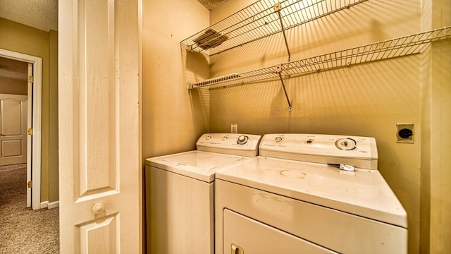 clothes washing area featuring baseboards, laundry area, carpet flooring, and washer and dryer