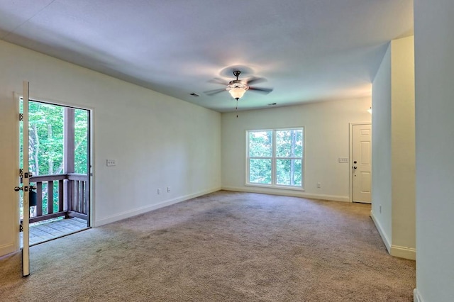 carpeted spare room with ceiling fan and a wealth of natural light