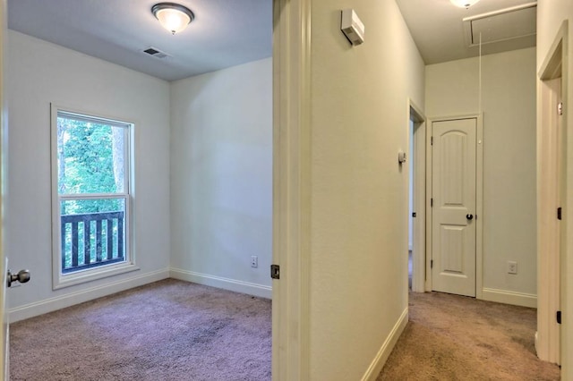 hallway featuring light carpet