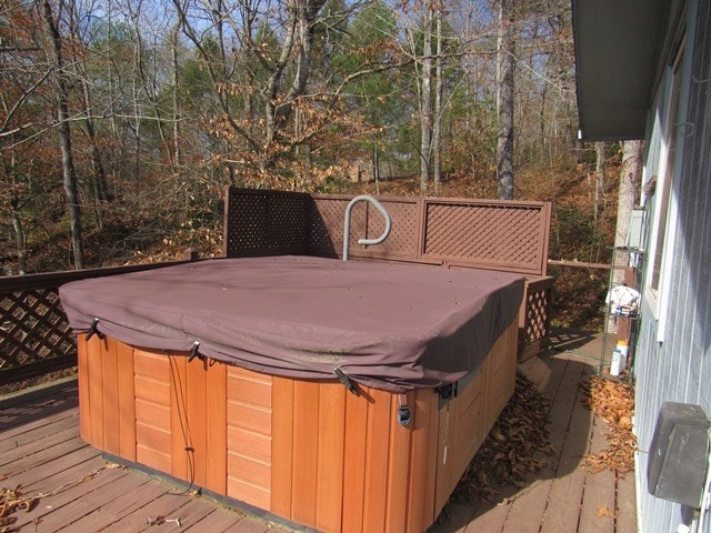 wooden terrace featuring a hot tub