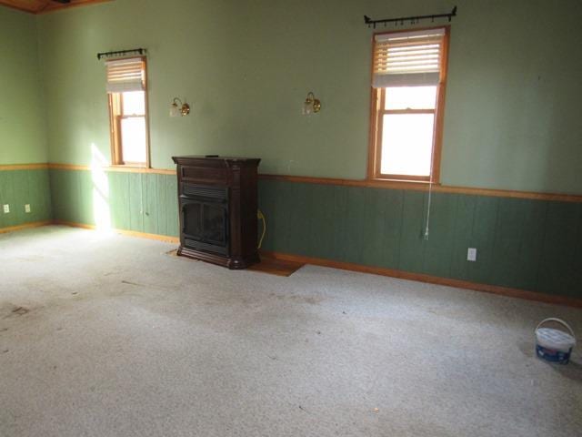 carpeted spare room featuring a wealth of natural light