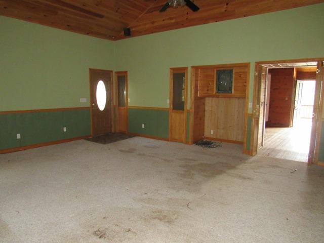 unfurnished living room with high vaulted ceiling and wooden ceiling